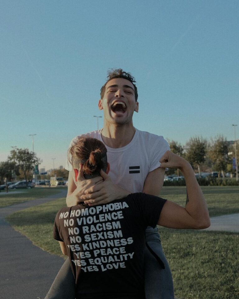 A joyful couple embraces equality and joy in an outdoor setting in İstanbul, Turkey.